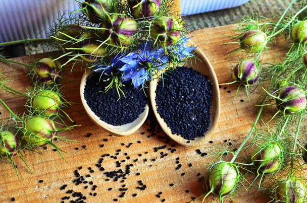 Close-up of dried Nigella sativa seeds, also known as black cumin, with distinctive black color, used for natural remedies, skincare, and culinary purposes, available in bulk as coarse cut for B2B export, suitable for herbal teabags